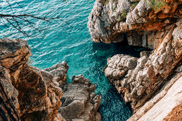 Rocks on the sea in Montenegro. Rocky coast. Wild beach. Dangerous coast.