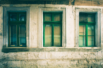 Old window with cracked paint, vintage brick wall background with old window