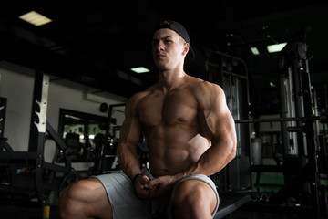 Obraz na płótnie Canvas Man Rests In Gym After Having A Workout