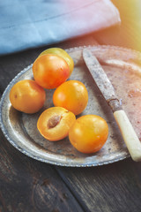 Yellow mirabelle plums in rustic metal dish