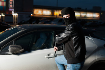Fototapeta na wymiar Male car thief open door with jemmy