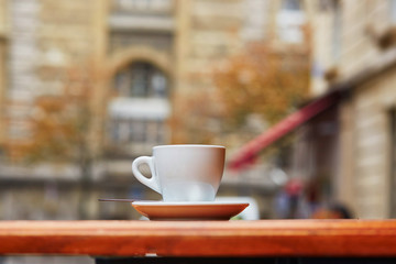 Cup with hot beverage in Parisian outdoor cafe