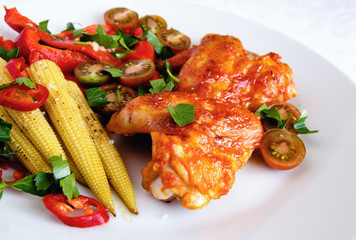 marinated in hot tomato and garlic roasted chicken wings with vegetables