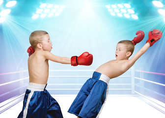 Boxers fighting in boxing ring.The big wins.	Little champion.