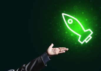 Man palm presenting Rocket web icon as technology concept
