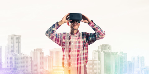 Guy wearing checked shirt and virtual mask demonstrating some em