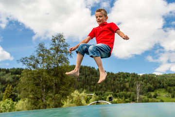 Child jumping on trampoline