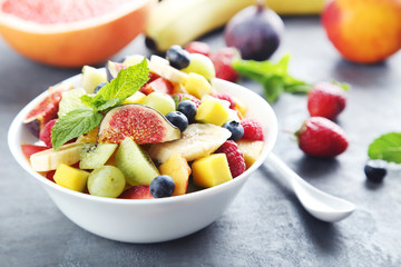 Fresh fruit salad on a grey wooden table