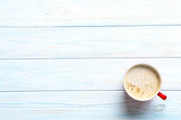 Cup of coffee on a blue wooden table