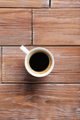 Cup of coffee on a brown wooden table