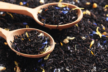 Heap of dry tea in wooden spoon