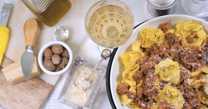 Dolly view of delicious steamy tortellini in bolognese sauce