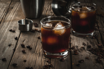 Alcohol. Drinks, Boozy Black Russian cocktail with vodka and coffee liquor on rustic wooden table. copy space