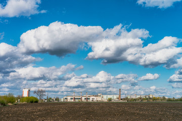 Fototapeta na wymiar Industrial buildings in the sunny day with cloud and blue sky