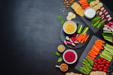 Variation of healthy vegan snacks. Vegetables, crackers, dip and hummus