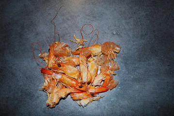 Shelled/peeled prawn isolated on a grey background.