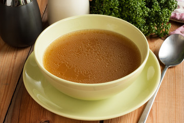 Bone broth made from beef, served in a green soup bowll