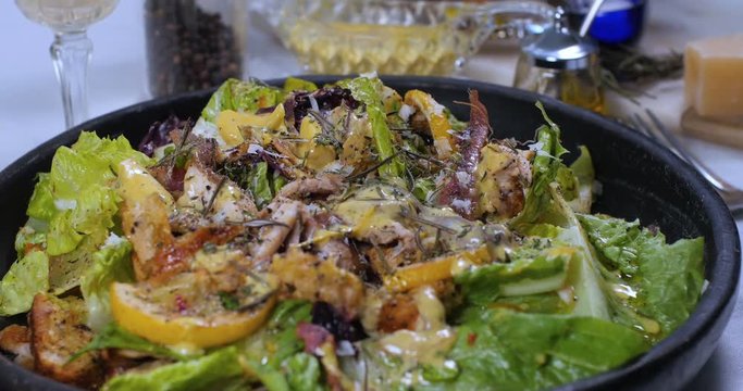 Dolly close up push in view of a delicious Caesar's salad