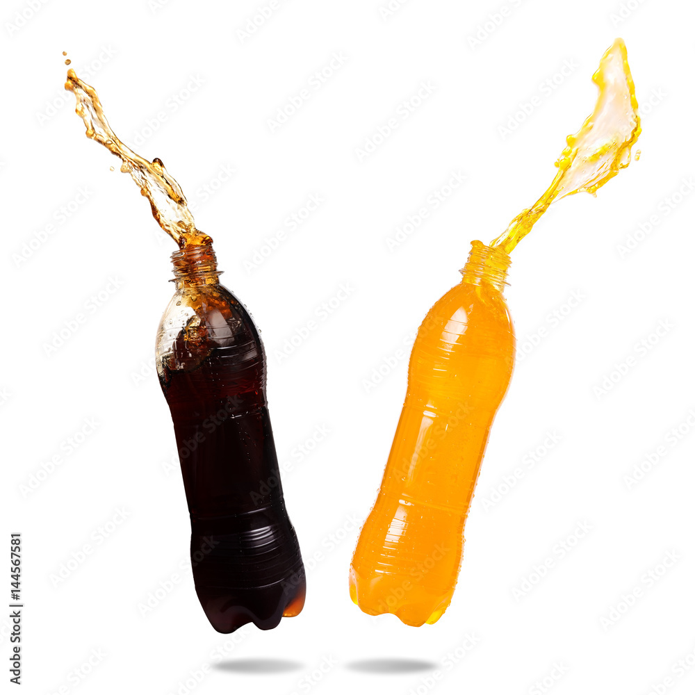 Wall mural orange juice and cola splash out of bottle on white background.