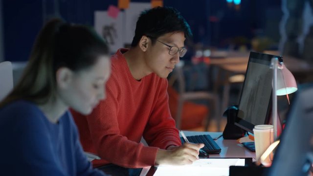  Young computer game designer drawing & working on computer
