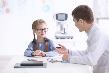 Cute little girl in ophthalmologist's office