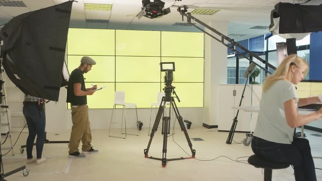 4K Time lapse of TV crew in studio, setting up for a shoot & packing away after.

