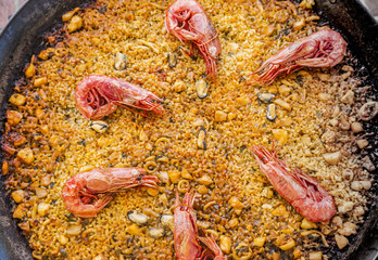 Fototapeta na wymiar Spanish delicious paella in a big pan called paella. Rice with seafood