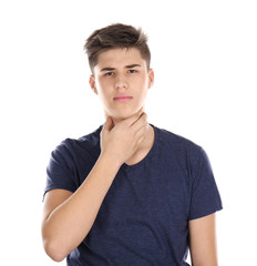 Sick young man having pain in throat on white background