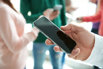 Male hand with smartphone, closeup