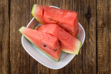 Portion of Fresh Watermelon on wooden background (selective focus).