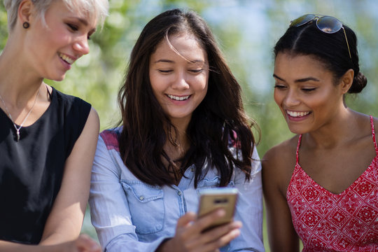 Female friends looking at smartphone