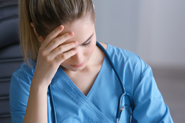Tired medical assistant in her office