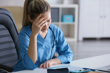 Tired medical assistant in her office