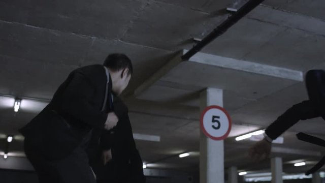  Asian gangster fighting in dark parking lot with members of a rival gang