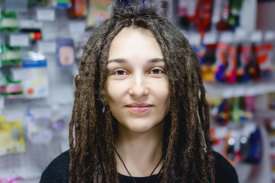 Portrait of a girl with dreadlocks in a store