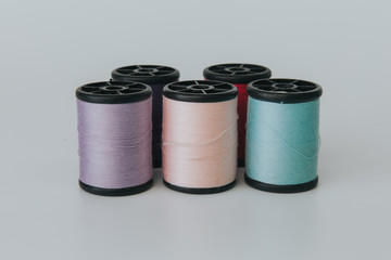 Thread bobbin on white background with vintage filter.