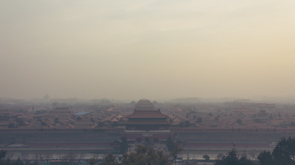 High and wide angle horizontal shot of the Forbidden City in Beijing China, on a foggy day.