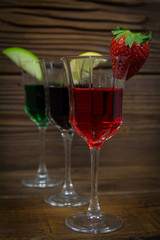 Cocktails fruity alcoholic drinks in glasses on wooden background