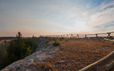 Split Rail Fence at sunrise above Lost Water Canyon in the Pryor Mountains range on the Montana Wyoming state line USA