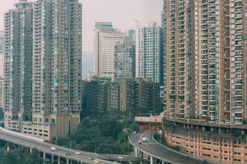 Fototapeta premium Chongqing, China - Dec 22, 2015: The view of foggy crowded city beside the jialing river and roads