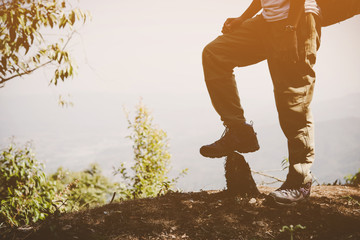 Close up of woman traveler with backpack on mountain landscape. Travel concept.