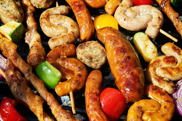 Assorted types of meat and vegetables on the grill