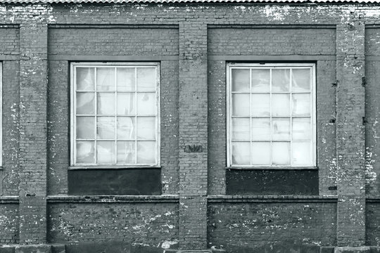 brick wall of an old factory with windows