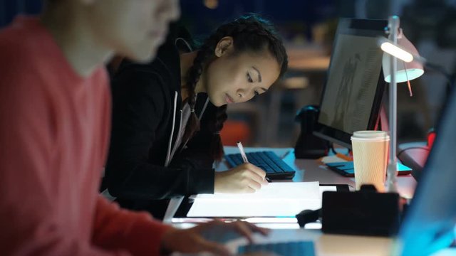  Young computer game designer drawing & working on computer