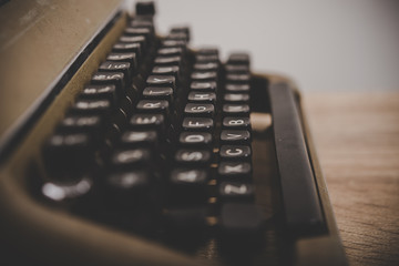 Vintage typewriter on wooden table.