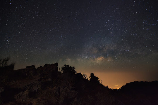 Milky Way Galaxy at Doi Luang Chiang Dao with Thai Language top point signs. Long exposure photograph.With grain