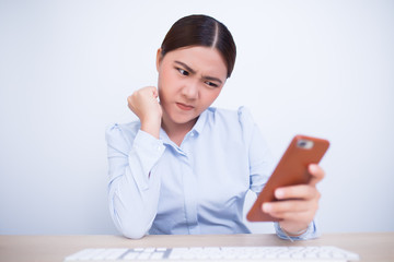Angry woman use the smartphone in office