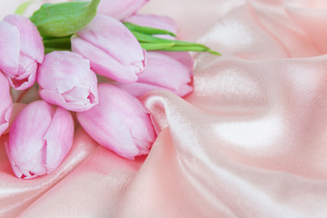 Obraz na płótnie Canvas Flowers on a silk fabric