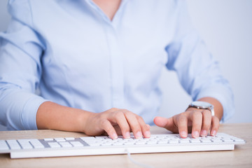 Female hands typing on the keyboard