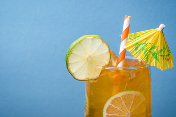 cocktail with lemon against the background of blue/cocktail with straws and lemon on a blue...